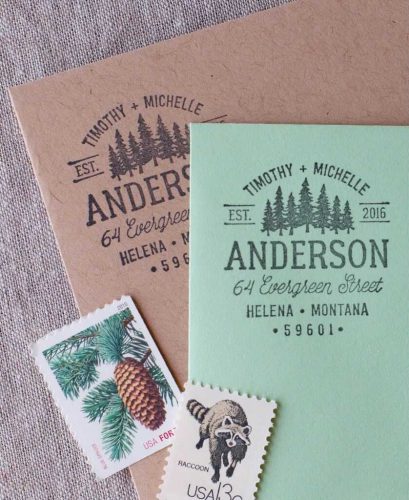 Custom Anderson family address stamp with evergreen trees on mint green and kraft paper with nature-themed postage stamps