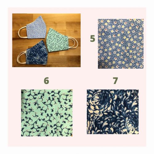 Handmade fabric face masks in floral patterns - blue, green, and navy designs with elastic ear loops on wooden surface
