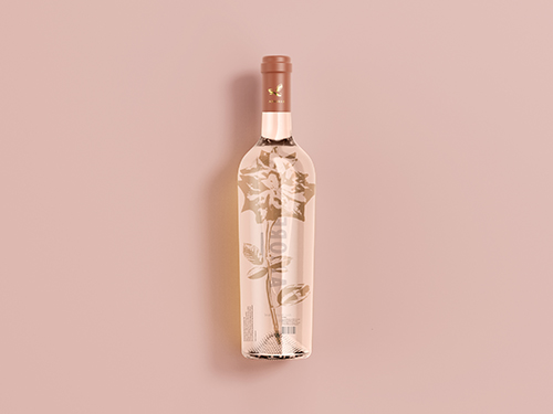 Elegant rose wine bottle with dried flower inside against soft pink background for romantic gifting occasions
