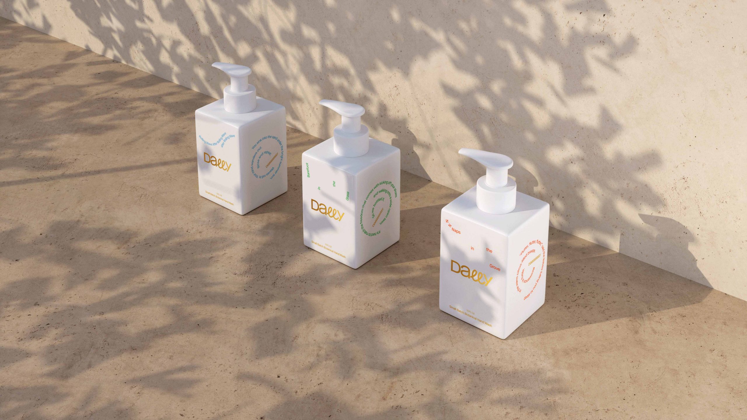 Three white Dewey brand pump bottles with colorful labels arranged on sandy surface with palm leaf shadows overhead